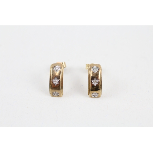 36 - 9ct gold diamond three stone half hoop earrings with starburst motif (1.3g)