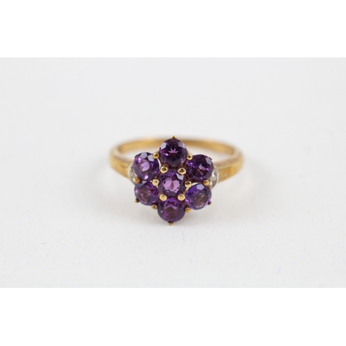 42 - 9ct gold amethyst seven stone floral cluster ring with diamond sides (2.7g) Size  Q 1/2