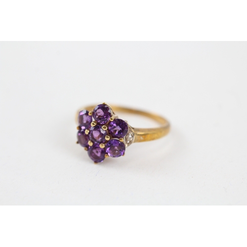 42 - 9ct gold amethyst seven stone floral cluster ring with diamond sides (2.7g) Size  Q 1/2