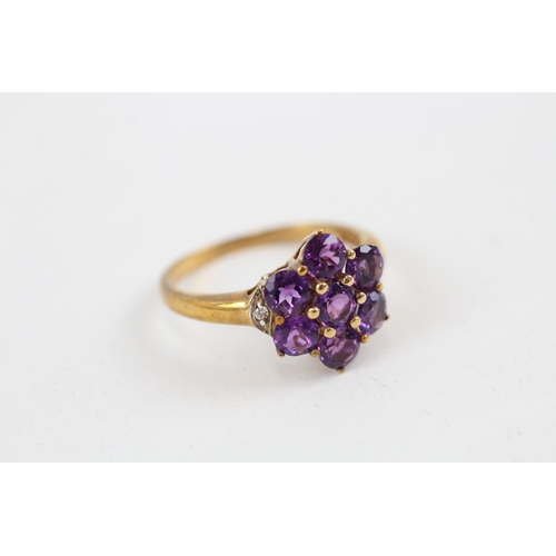 42 - 9ct gold amethyst seven stone floral cluster ring with diamond sides (2.7g) Size  Q 1/2