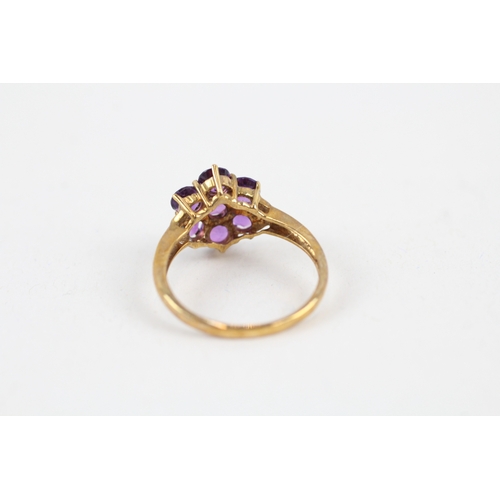 42 - 9ct gold amethyst seven stone floral cluster ring with diamond sides (2.7g) Size  Q 1/2