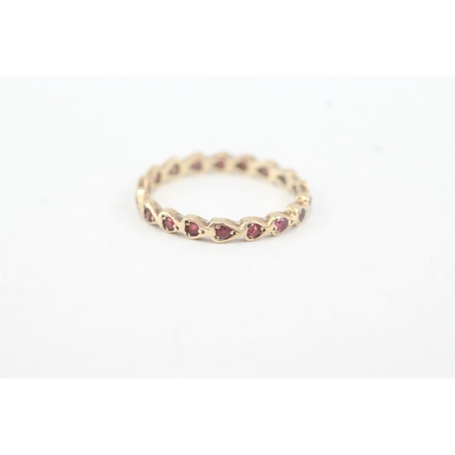 92 - 9ct gold ruby full eternity ring (1.3g) MISHAPEN  Size  M 1/2