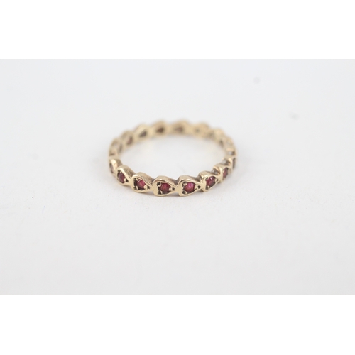 92 - 9ct gold ruby full eternity ring (1.3g) MISHAPEN  Size  M 1/2