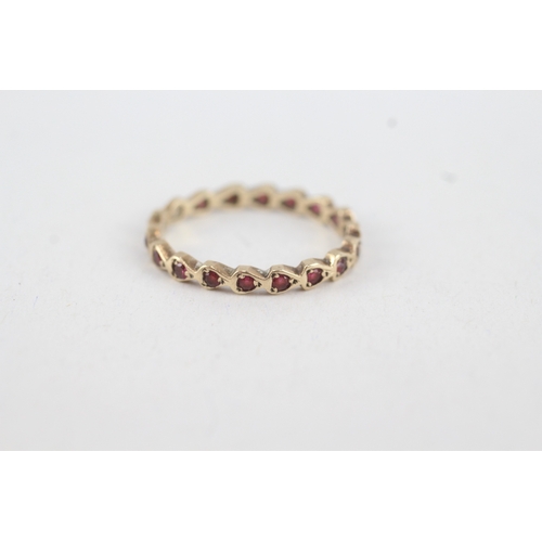 92 - 9ct gold ruby full eternity ring (1.3g) MISHAPEN  Size  M 1/2