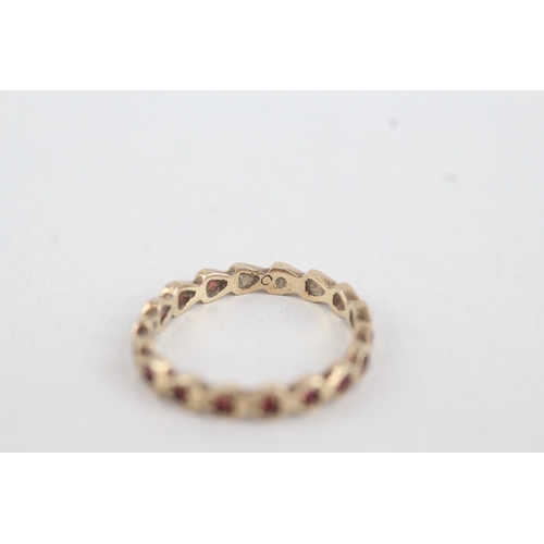 92 - 9ct gold ruby full eternity ring (1.3g) MISHAPEN  Size  M 1/2