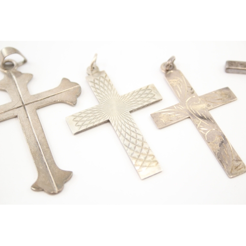 312 - Five silver cross pendants including etched (44g)