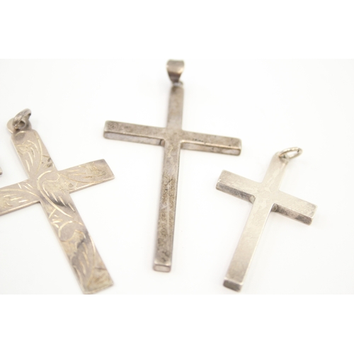 312 - Five silver cross pendants including etched (44g)