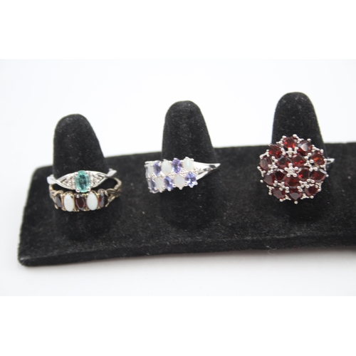 317 - A collection of silver gemstone rings including Tanzanite (23g)