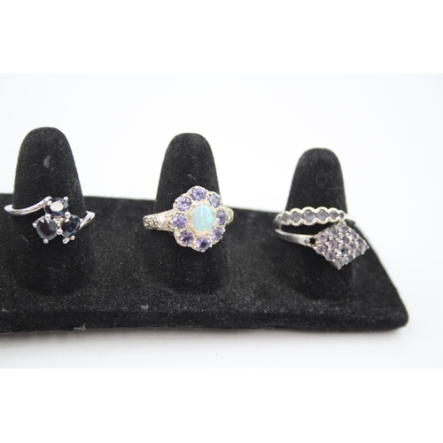 317 - A collection of silver gemstone rings including Tanzanite (23g)