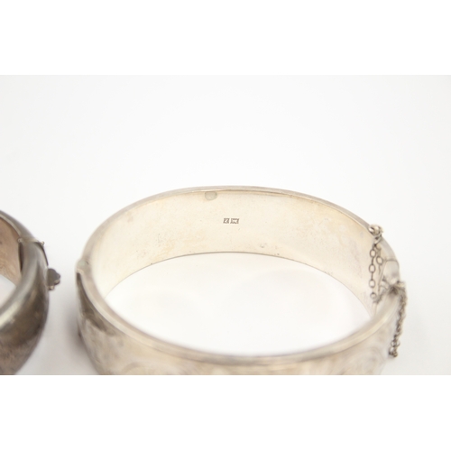 325 - Two silver bangles with etched designs (58g)