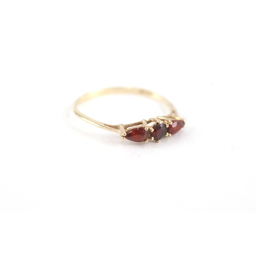 74 - 9ct gold garnet three stone ring (0.8g) Size  N 1/2