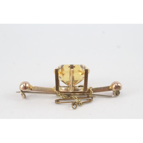 91 - 9ct gold hexagonal citrine single stone bar brooch with base metal pin (6.6g)