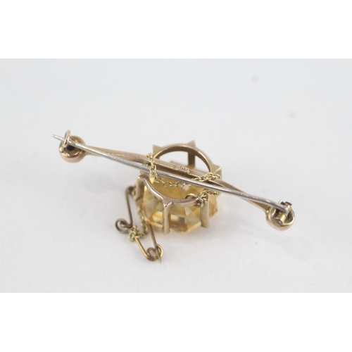 91 - 9ct gold hexagonal citrine single stone bar brooch with base metal pin (6.6g)