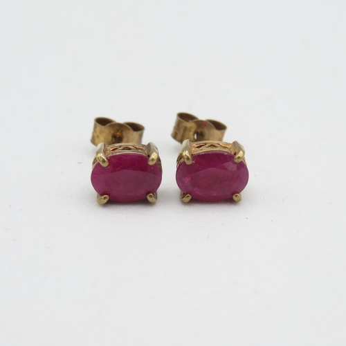 101 - 9ct gold oval cut ruby stud earrings (1.1g)