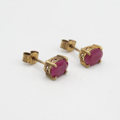 101 - 9ct gold oval cut ruby stud earrings (1.1g)