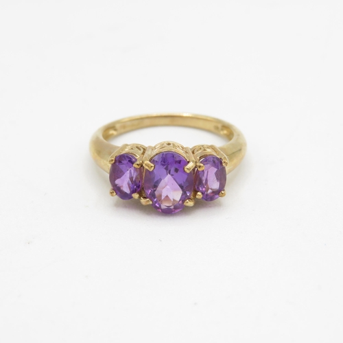 131 - 9ct gold amethyst three stone ring (3.4g) Size  N 1/2