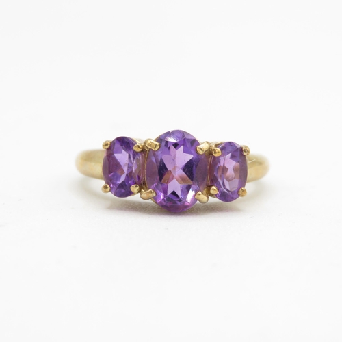 131 - 9ct gold amethyst three stone ring (3.4g) Size  N 1/2