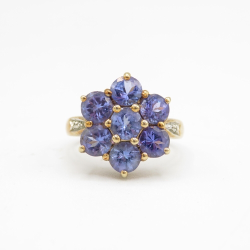 135 - 9ct gold tanzanite seven stone ring with diamond set shoulders (4.8g) Size  N 1/2