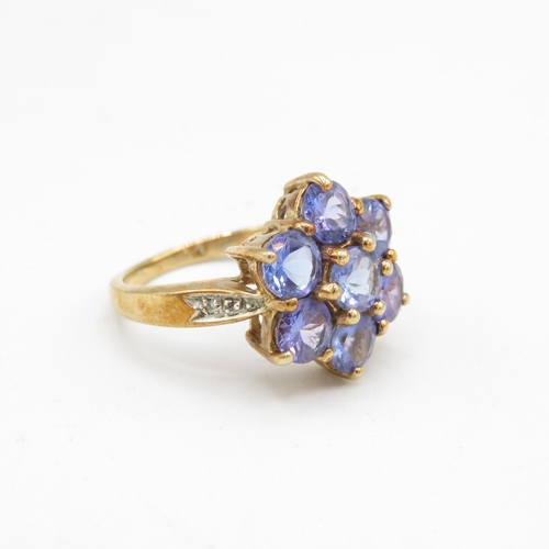 135 - 9ct gold tanzanite seven stone ring with diamond set shoulders (4.8g) Size  N 1/2