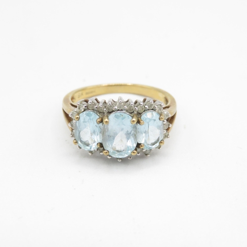 202 - 9ct gold oval cut blue topaz & diamond dress ring (3.9g) Size  Q