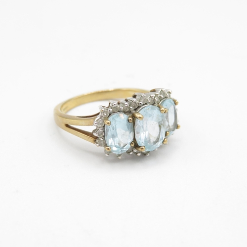 202 - 9ct gold oval cut blue topaz & diamond dress ring (3.9g) Size  Q