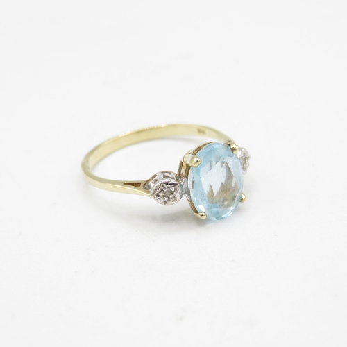 205 - 9ct gold oval cut blue topaz & diamond three stone ring (1.9g) Size  N 1/2