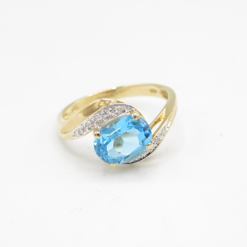 208 - 9ct gold oval cut blue topaz & diamond dress ring (2.6g) Size  P