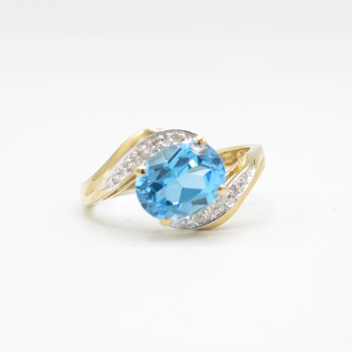 208 - 9ct gold oval cut blue topaz & diamond dress ring (2.6g) Size  P