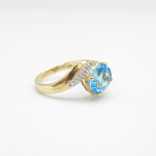 208 - 9ct gold oval cut blue topaz & diamond dress ring (2.6g) Size  P