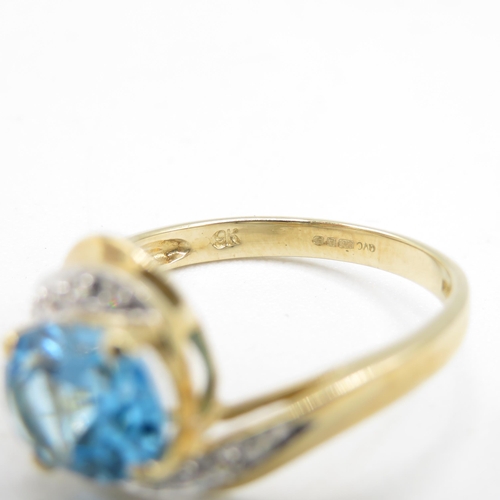 208 - 9ct gold oval cut blue topaz & diamond dress ring (2.6g) Size  P