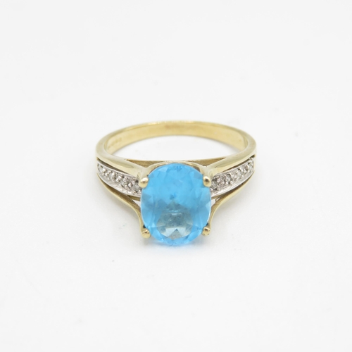 209 - 9ct gold oval cut blue topaz & diamond dress ring (3.3g) Size  Q