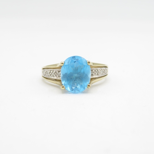 209 - 9ct gold oval cut blue topaz & diamond dress ring (3.3g) Size  Q