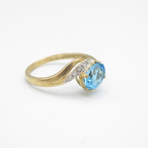 220 - 9ct gold oval cut blue topaz & diamond dress ring (3.1g) Size  W