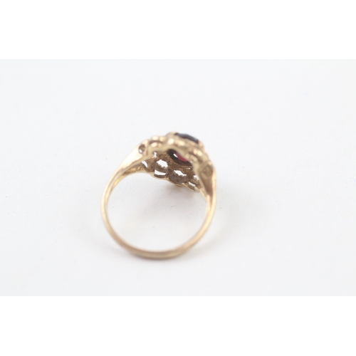 106 - 10kt gold floral surround garnet set dress ring (2.2g) Size  I