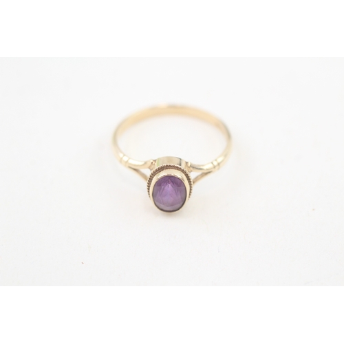 62 - 9ct gold rope edged oval cut amethyst set solitaire ring (1.5g) Size  M 1/2