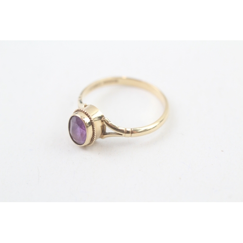 62 - 9ct gold rope edged oval cut amethyst set solitaire ring (1.5g) Size  M 1/2