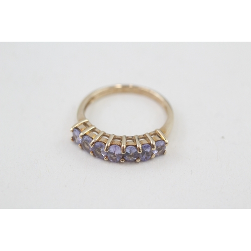 80 - 9ct gold oval cut tanzanite half eternity ring, claw set (2.5g) Size  N