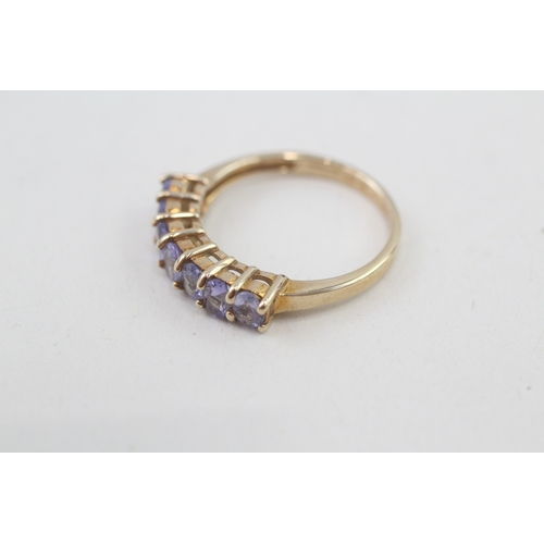 80 - 9ct gold oval cut tanzanite half eternity ring, claw set (2.5g) Size  N