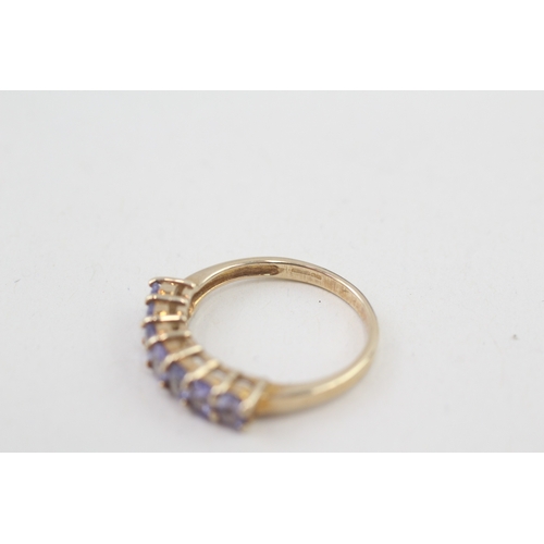 80 - 9ct gold oval cut tanzanite half eternity ring, claw set (2.5g) Size  N