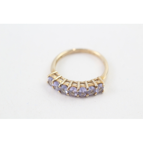 80 - 9ct gold oval cut tanzanite half eternity ring, claw set (2.5g) Size  N