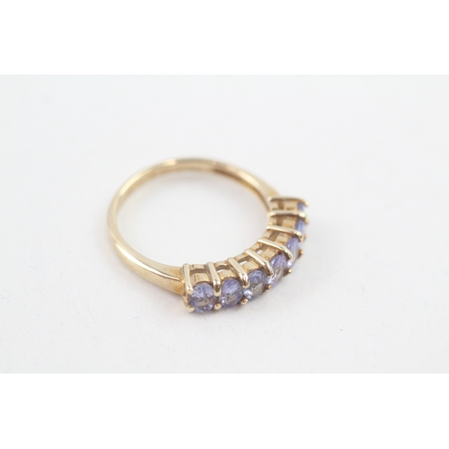 80 - 9ct gold oval cut tanzanite half eternity ring, claw set (2.5g) Size  N