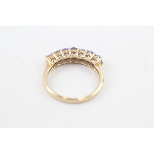 80 - 9ct gold oval cut tanzanite half eternity ring, claw set (2.5g) Size  N