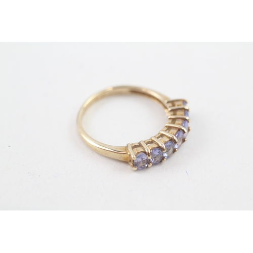 80 - 9ct gold oval cut tanzanite half eternity ring, claw set (2.5g) Size  N