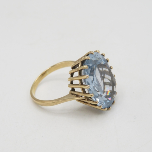 48 - 9ct gold oval cut blue gemstone dress ring, claw set (7.7g) Size  R 1/2