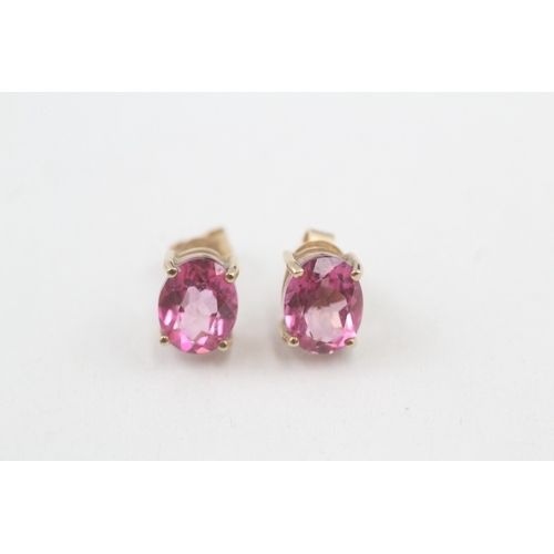 59 - 9ct gold 'pink' topaz single stone stud earrings (2.3g)