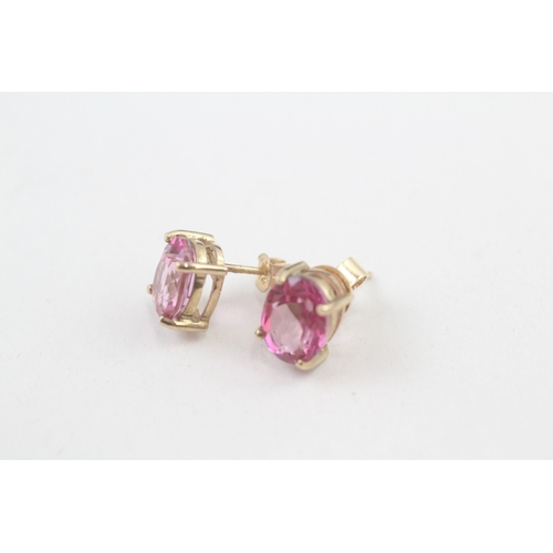 59 - 9ct gold 'pink' topaz single stone stud earrings (2.3g)