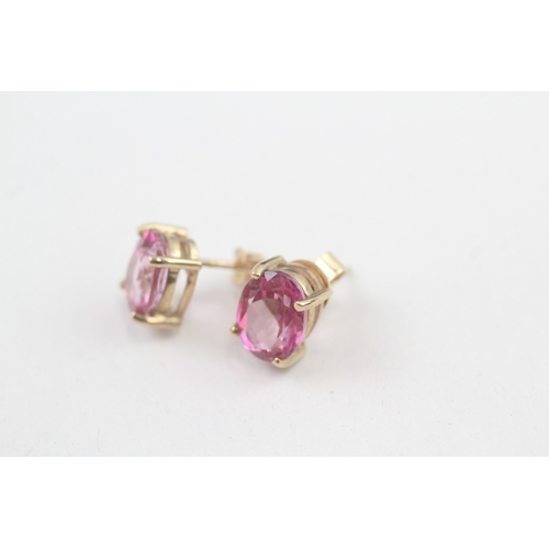 59 - 9ct gold 'pink' topaz single stone stud earrings (2.3g)