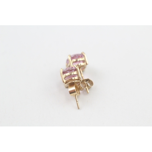 59 - 9ct gold 'pink' topaz single stone stud earrings (2.3g)