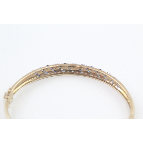 60 - 9ct gold diamond & sapphire hinged bangle (11g)