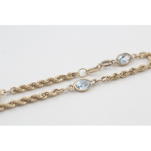 62 - 9ct gold topaz twisted link bracelet (1.8g)